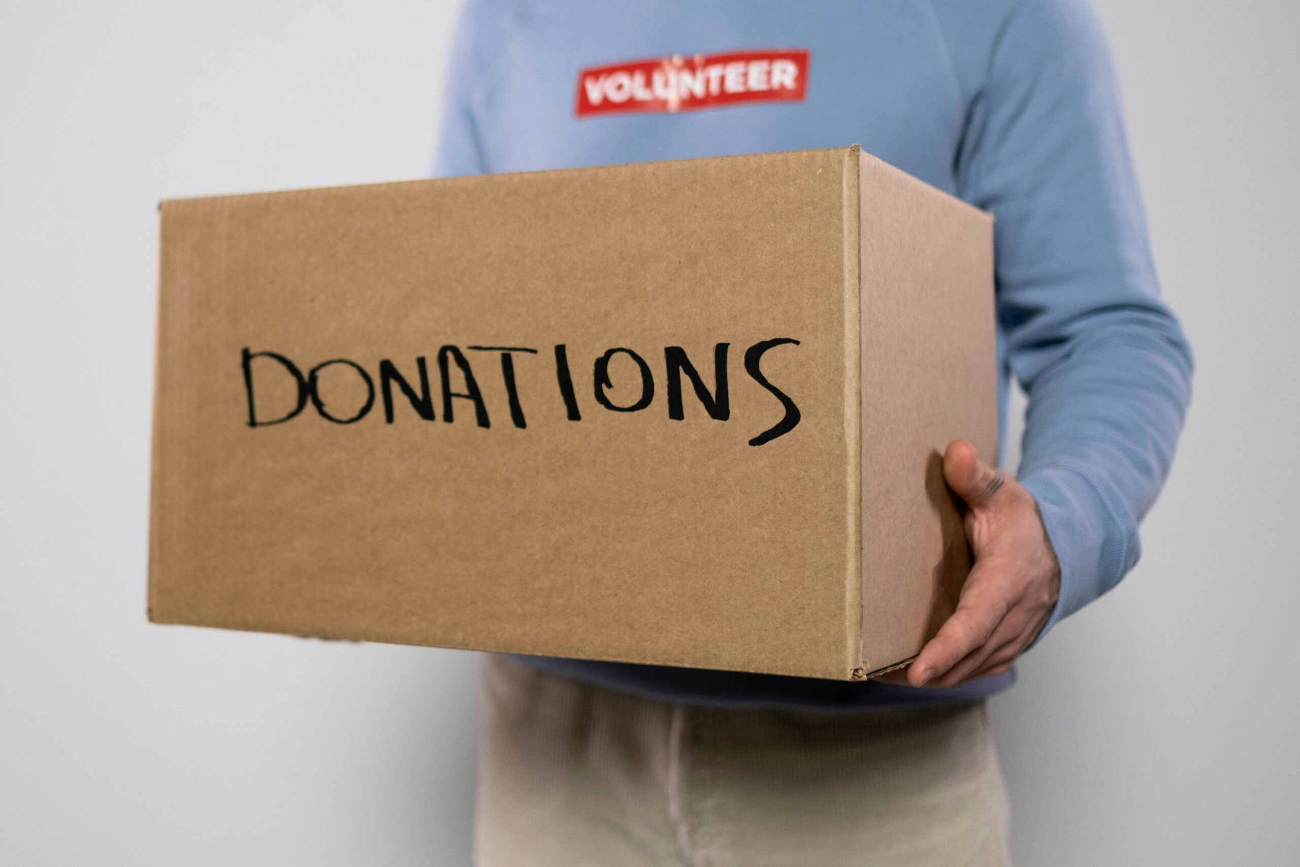 Volunteer holding donations box