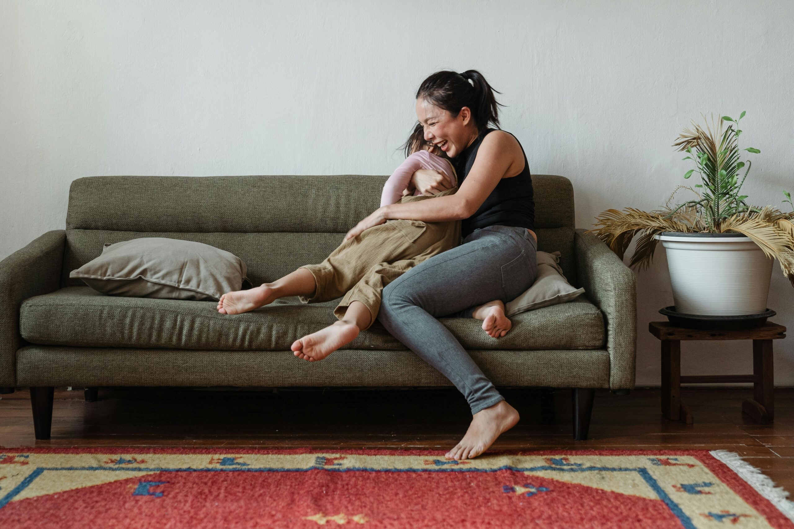 Mom hugging child on couch