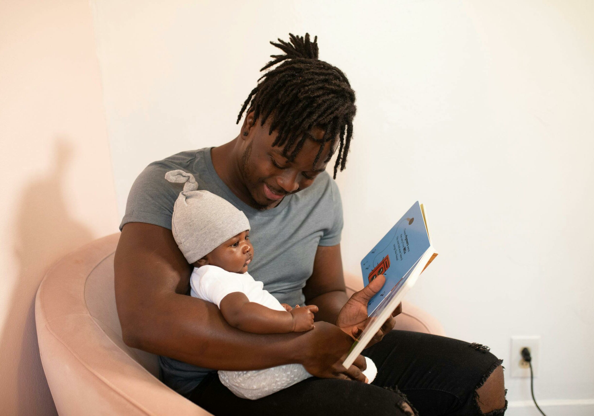 Dad reading book to baby